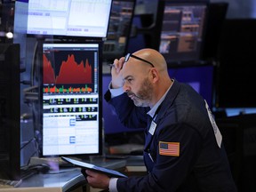 A trader works on the trading floor of the New York Stock Exchange.